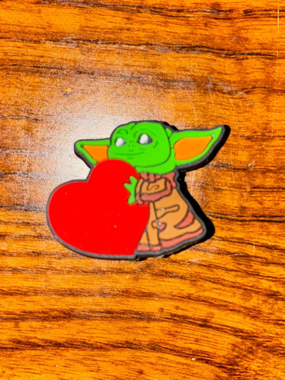 Baby yoda with a heart charm